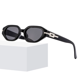 Chic cat-eye polygon sunglasses with black frames and gold chain metal temples
