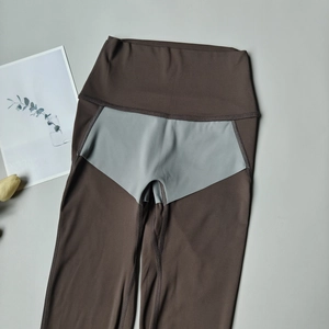 Flat lay of high-waisted seamless yoga leggings with contrast color stitching and texture