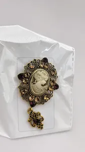 Detail of vintage medieval cameo brooch with crystals and hollow metal pendant