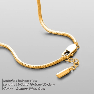 Detail of golden stainless steel snake chain bracelet with lobster clasp and extension