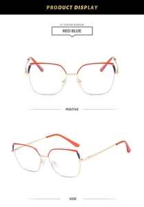 Detail view of red and blue cat-eye glasses frame with metallic gold accents