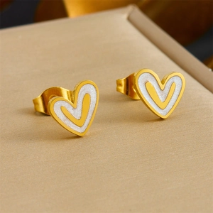Golden heart stud earrings with white enamel inlay and minimalist central heart outline