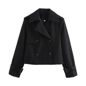 Detailed view of the double-breasted black cropped trench coat with classic epaulettes