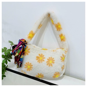 Close-up of white plush handbag featuring yellow daisy patterns and a silk scarf