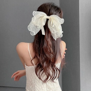 French style polka dot mesh bow hair clip elegantly styled on long wavy hair