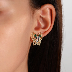Elegant gold butterfly stud earrings with colorful crystals on model, minimalist style