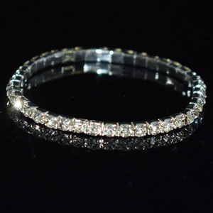 Detail shot of a single row sparkling crystal rhinestone bracelet on a black background