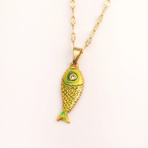 Detailed close-up of a gold koi fish pendant with yellow-green enamel and a crystal stone