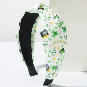 Detail showing St. Patrick's Day patterns with green shamrocks on knotted headband fabric