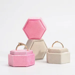 Elegant hexagonal velvet jewelry box in pink and cream with gold ring display