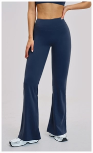 Macro detail of high-waist band on navy blue flare yoga pants showing stitching and fabric