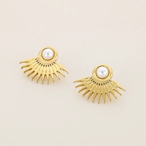 Macro view of gold sunflower pearl earrings with detailed metallic textures