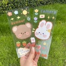 Close-up of cute cartoon bear and rabbit stickers made of transparent PVC material