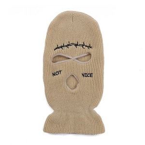 Detail of khaki 3-hole knitted balaclava showing NOT NICE embroidery and wire pattern