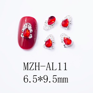 Macro view of 6.5x9.5mm red teardrop zircon nail charms with silver ornate base