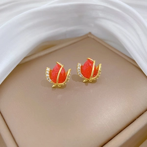 Detailed view of elegant red tulip bud earrings with gold metal and tiny crystals
