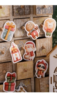 Detailed Christmas stickers featuring Santa and animals on a wooden advent calendar box
