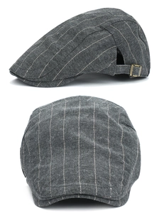 Detail view of dark grey striped cotton beret with adjustable bronze metal buckle side