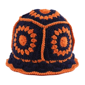 Close-up of handmade crochet granny square bucket hat in navy blue and orange wool knit