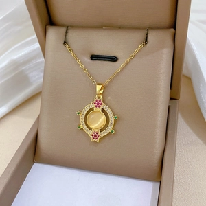 Macro view of gold cat eye stone pendant with sparkling zircon accents in a gift box