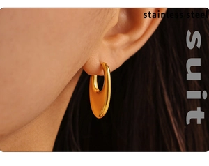 Close-up of a model wearing a polished gold U-shaped earring made of durable stainless steel