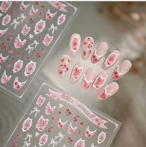 Detail of floral nail stickers featuring pink roses and white lace bow designs