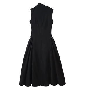 Sleeveless black A-line dress with side silver metal buckle detail on a white background