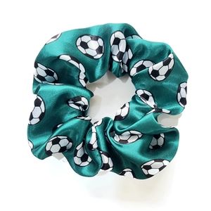 Green satin scrunchie with classic soccer ball print and shiny elastic fabric texture