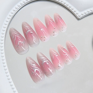 Pink gradient almond press-on nails with silver heart lines and metallic bead accents