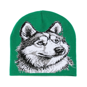 Detailed close-up of a green knitted beanie featuring a grey husky dog jacquard pattern