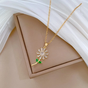 Detail of sunflower pendant with sparkling zircons and green leaves on chain