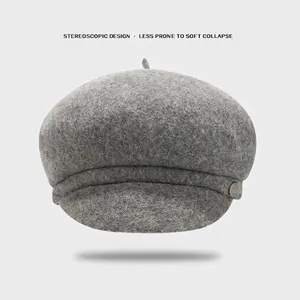 Deep grey thick wool newsboy cap with structured silhouette and metallic button