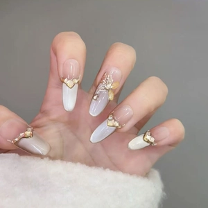 Long almond cat eye press-on nails with 3D gold butterfly and crystal diamond accents