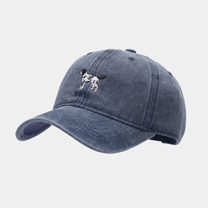 Close-up of a vintage navy blue washed cotton baseball cap with dog embroidery