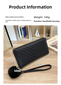 Detail of black long wallet with V-stitch pattern, hand strap, pompom and 140g weight label