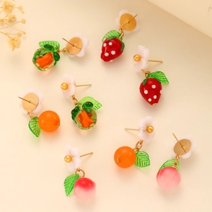 Detail of colorful fruit earrings featuring orange and strawberry charms with resin petals