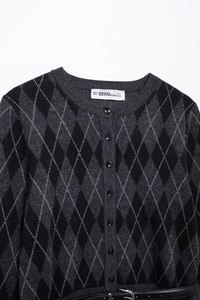 Detail view of a diamond pattern knitted cardigan with buttons and brand size label