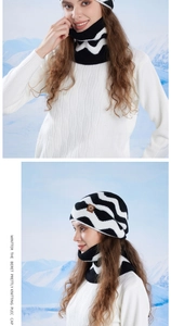 Detail of winter knitted beanie and neck warmer set with black and white wave patterns