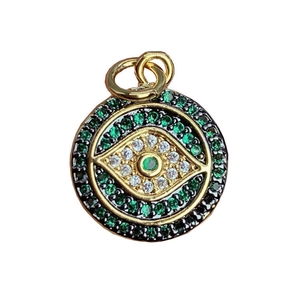 Gold plated evil eye pendant with green and white zircons on a white background