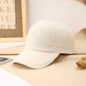 Minimalist cream knit wool blend baseball cap with a classic six-panel warm textured design