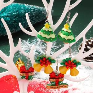 Christmas acrylic earrings set with festive Santa tree and bell designs on a white stand