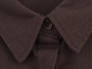 Detail of dark brown linen shirt collar featuring a single button and woven texture