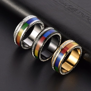 Rainbow striped stainless steel rings set with sparkling crystals in gold, silver, and black