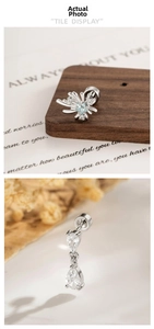 Macro detail of starburst ear stud with blue gem and pear-shaped zircon piercing jewelry