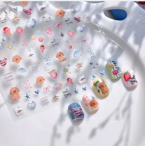 Detail of Korean puppy nail stickers with cute strawberry and rainbow patterns on tray