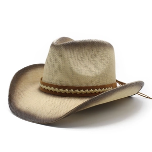 Close-up of a wide brim straw cowboy hat with hand-painted gradient edges and leather band