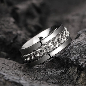 Macro detail of industrial punk style spinning chain ring with brushed silver finish