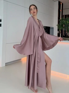 Detail of elegant dusty pink satin robe featuring side slit and smooth silk texture