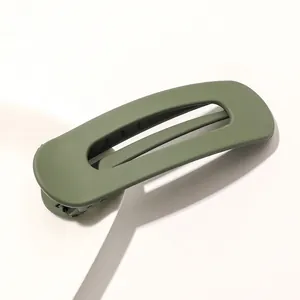 Detail view of avocado green matte finish hair clip with hollow rectangular design