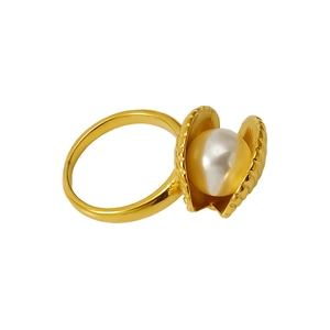 Detailed view of a golden shell ring featuring a large lustrous pearl center
